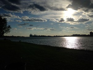 Belle Isle Beach with the sun setting by downtown Detroit.